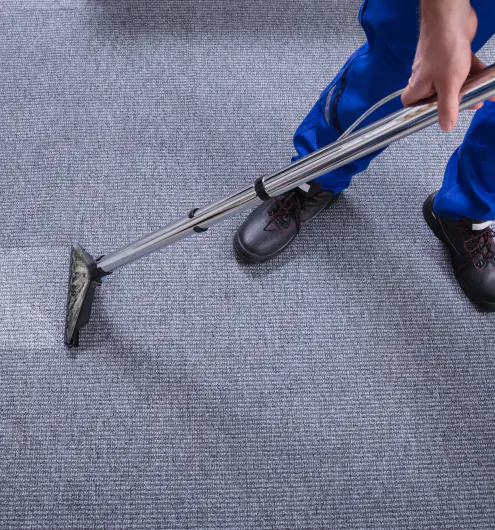 close up of a carpet cleaning contractor using a vacuum during carpet cleaning castaic ca